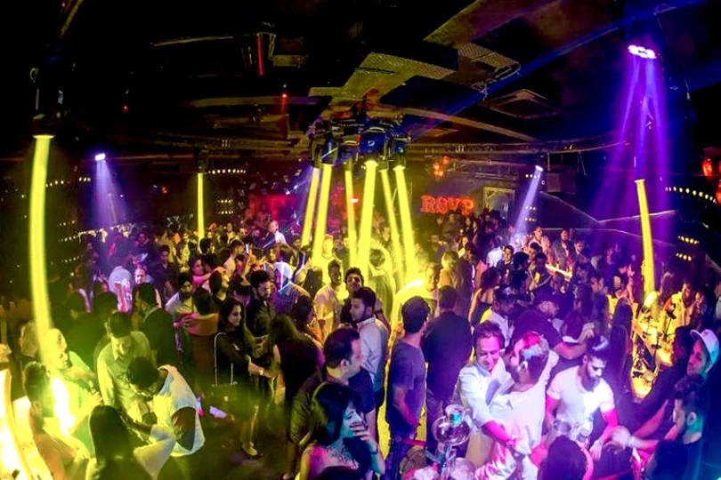 Yellow and purple laser beams over the dance floor at a Delhi club
