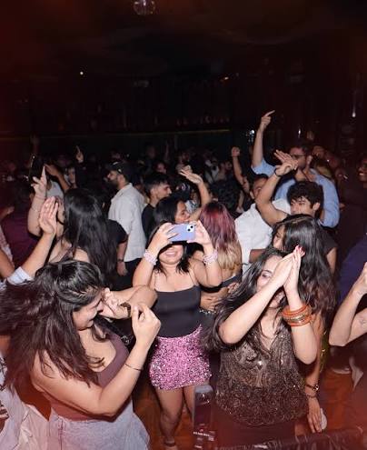 Group of dancers under a disco ball at a Mumbai club night