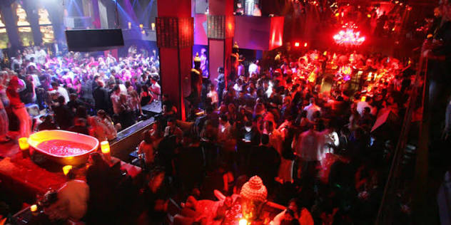 Multi-level red-lit club packed with dancers in Pune
